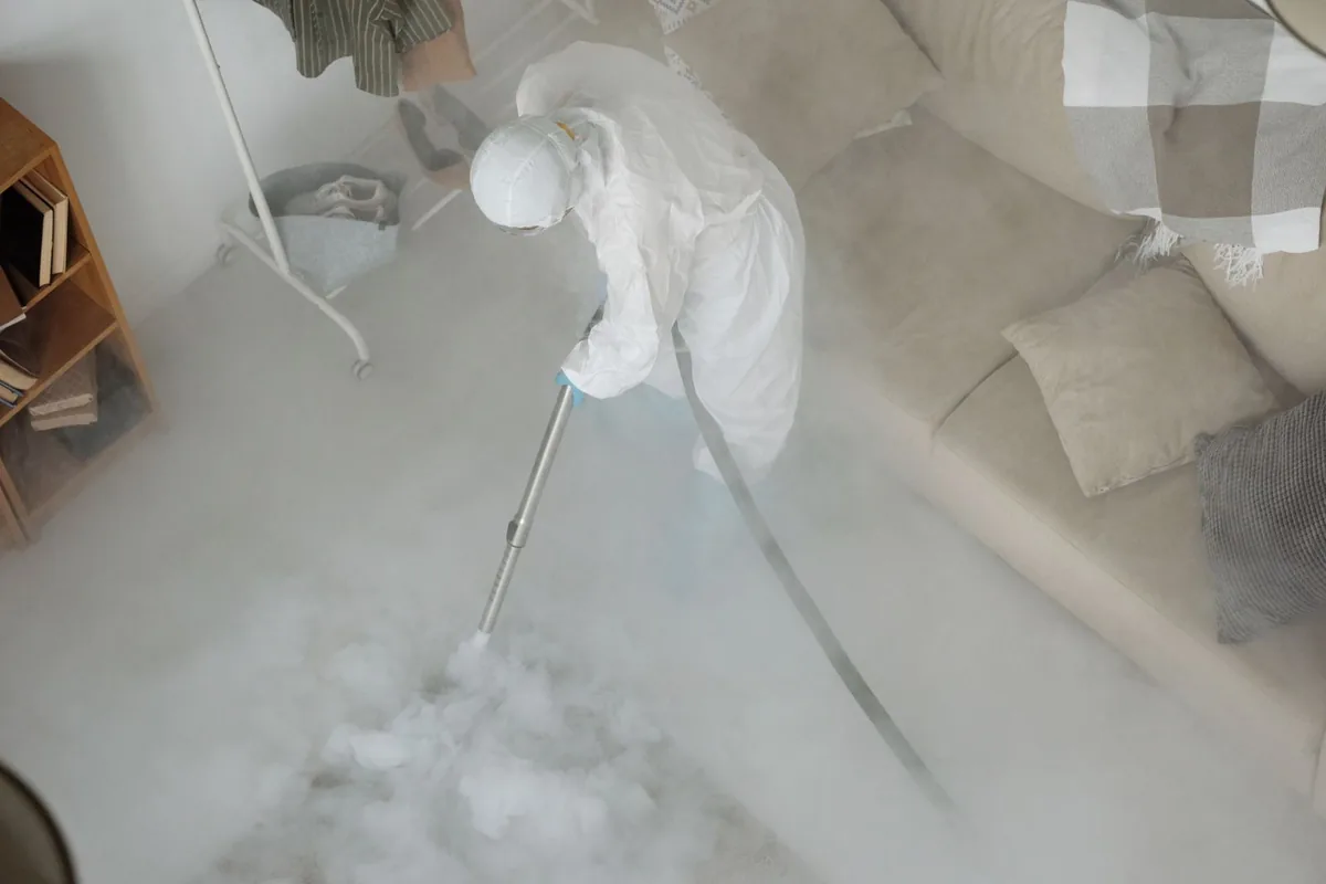 Biohazard cleanup technician in protective equipment, Casa View Haven, Dallas, TX